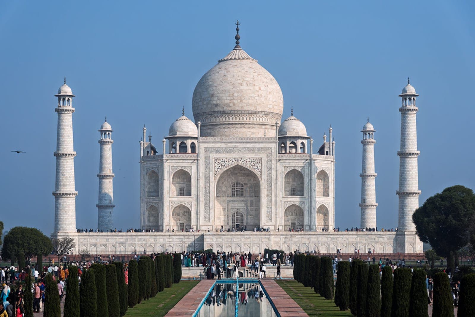 The Taj Mahal at sunrise seen across the reflecting pool